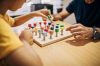 Preschool kid learning colors with occupational therapist